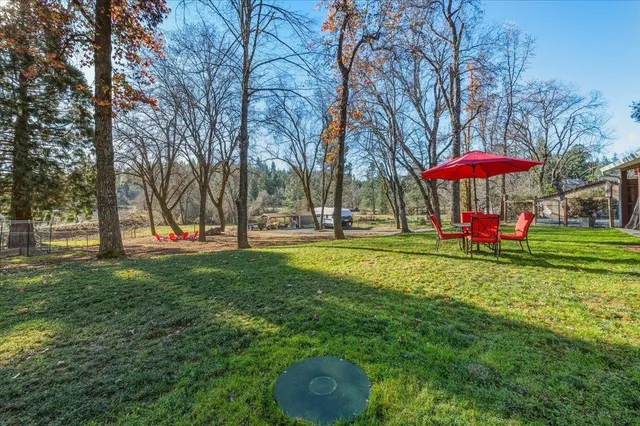 a view of deck with chairs and wooden fence