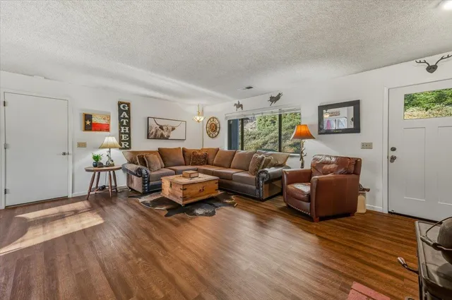 a living room with furniture and a wooden floor