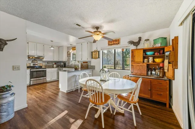 a dining room with furniture and wooden floor