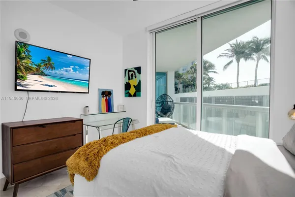 a bedroom with a bed and large window