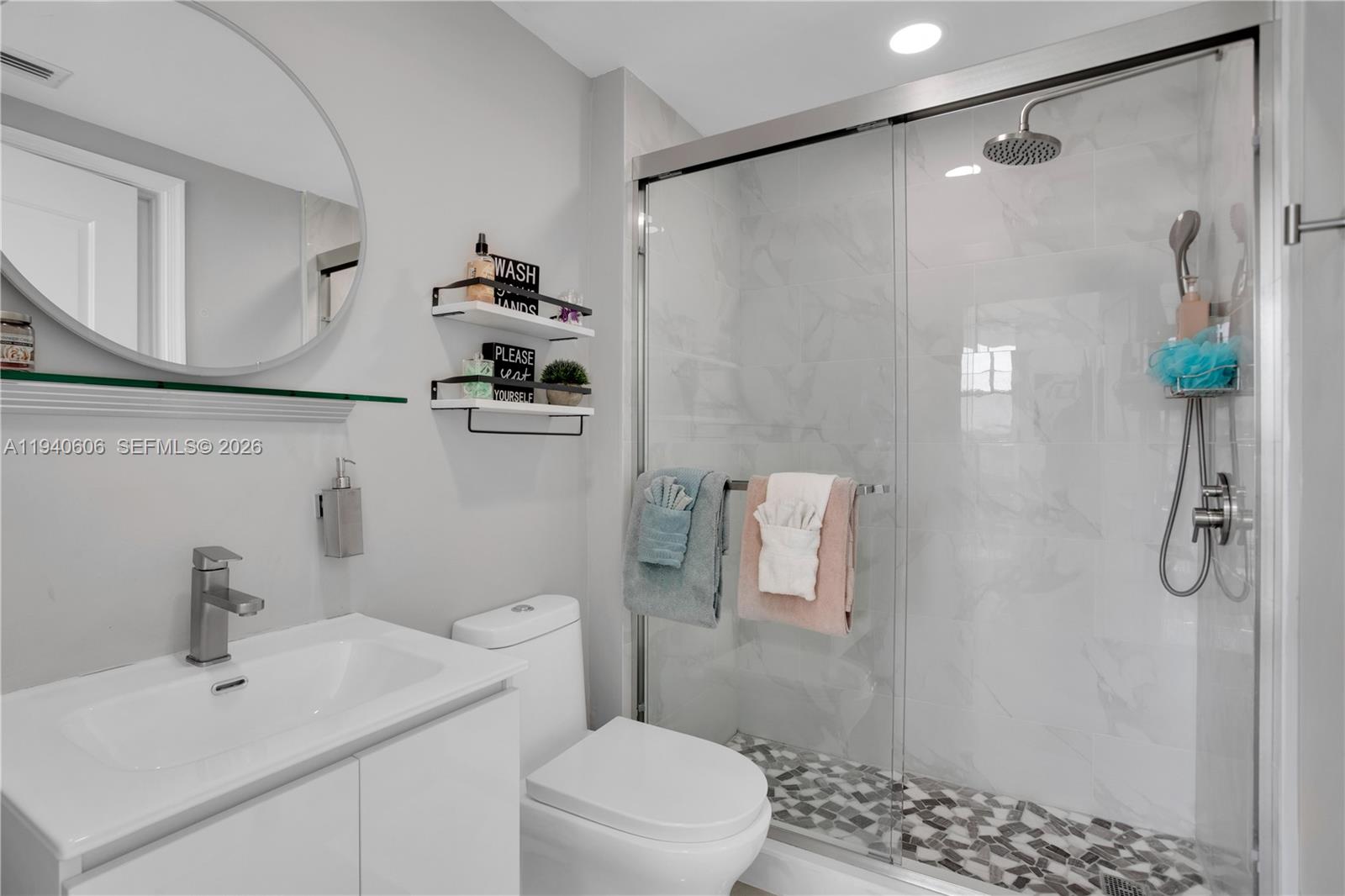 480 Northeast 30th Street, Unit 705 Miami, FL 33137 - Photo 17 of 32 a bathroom with a sink a toilet and shower