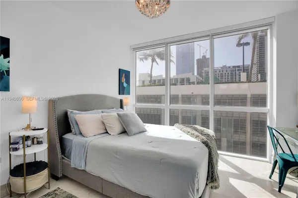 a bedroom with a large bed and a large window