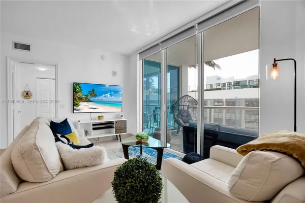 a living room with furniture a fireplace and a flat screen tv