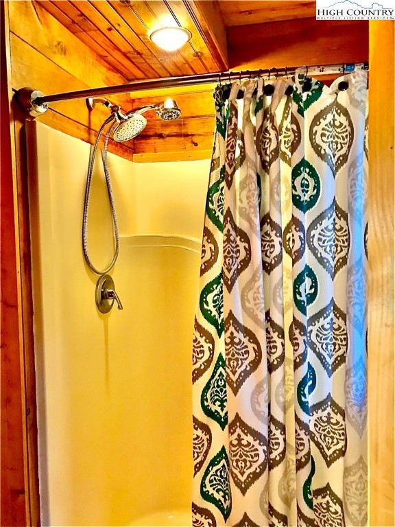 326 Buckshot Ridge Road Deep Gap, NC 28618 - Photo 25 of 29 a bathroom with a shower and a shower curtain