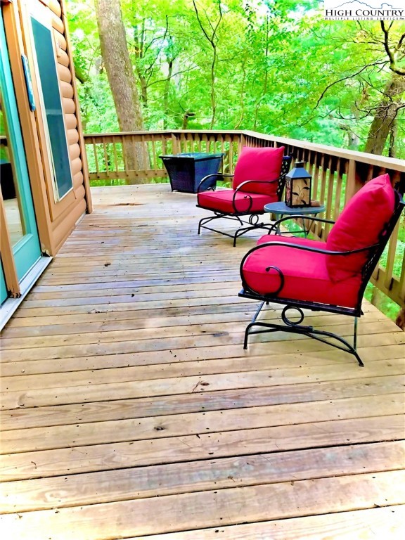 326 Buckshot Ridge Road Deep Gap, NC 28618 - Photo 4 of 29 a view of a deck with wooden floor and outdoor seating