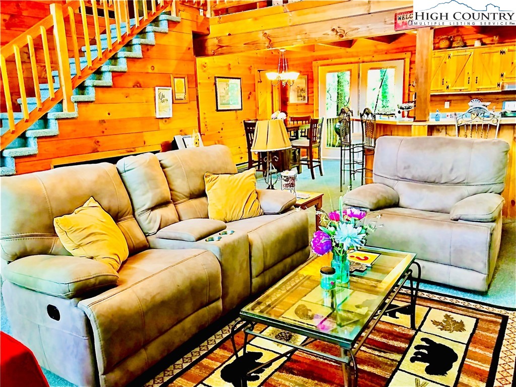 326 Buckshot Ridge Road Deep Gap, NC 28618 - Photo 8 of 29 a living room with furniture and a floor to ceiling window