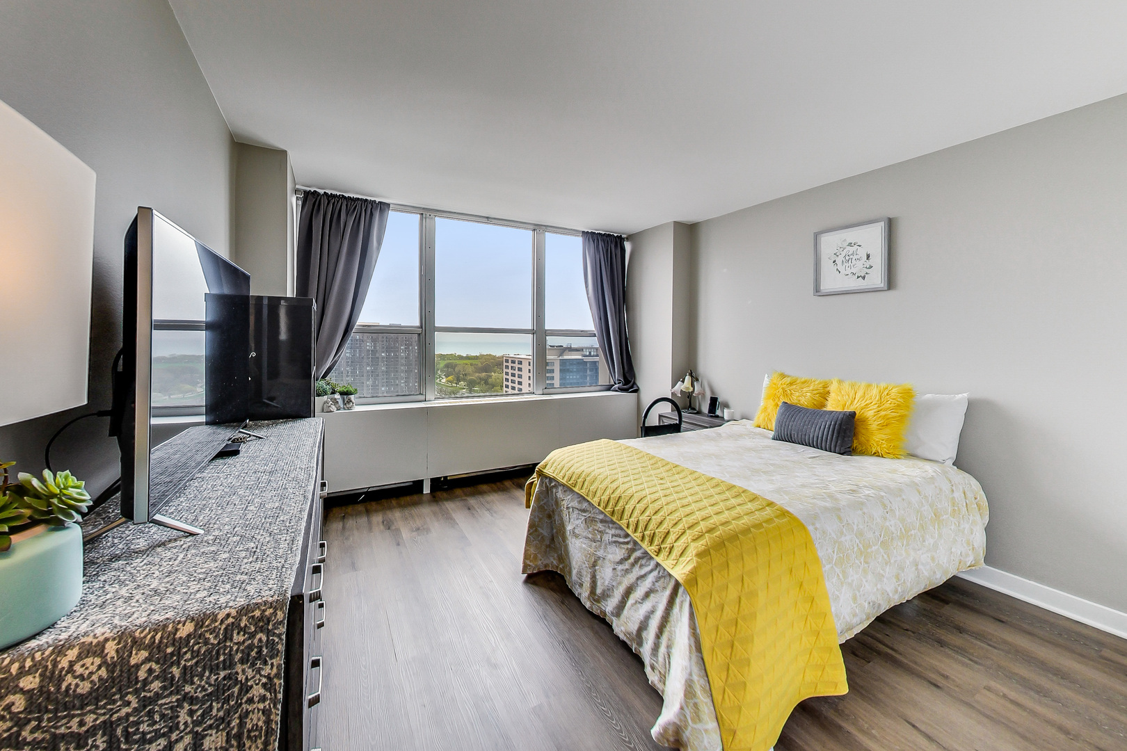 655 West Irving Park Road, Unit 2210 Chicago, IL 60613 - Photo 15 of 38 a bedroom with a bed window and dresser