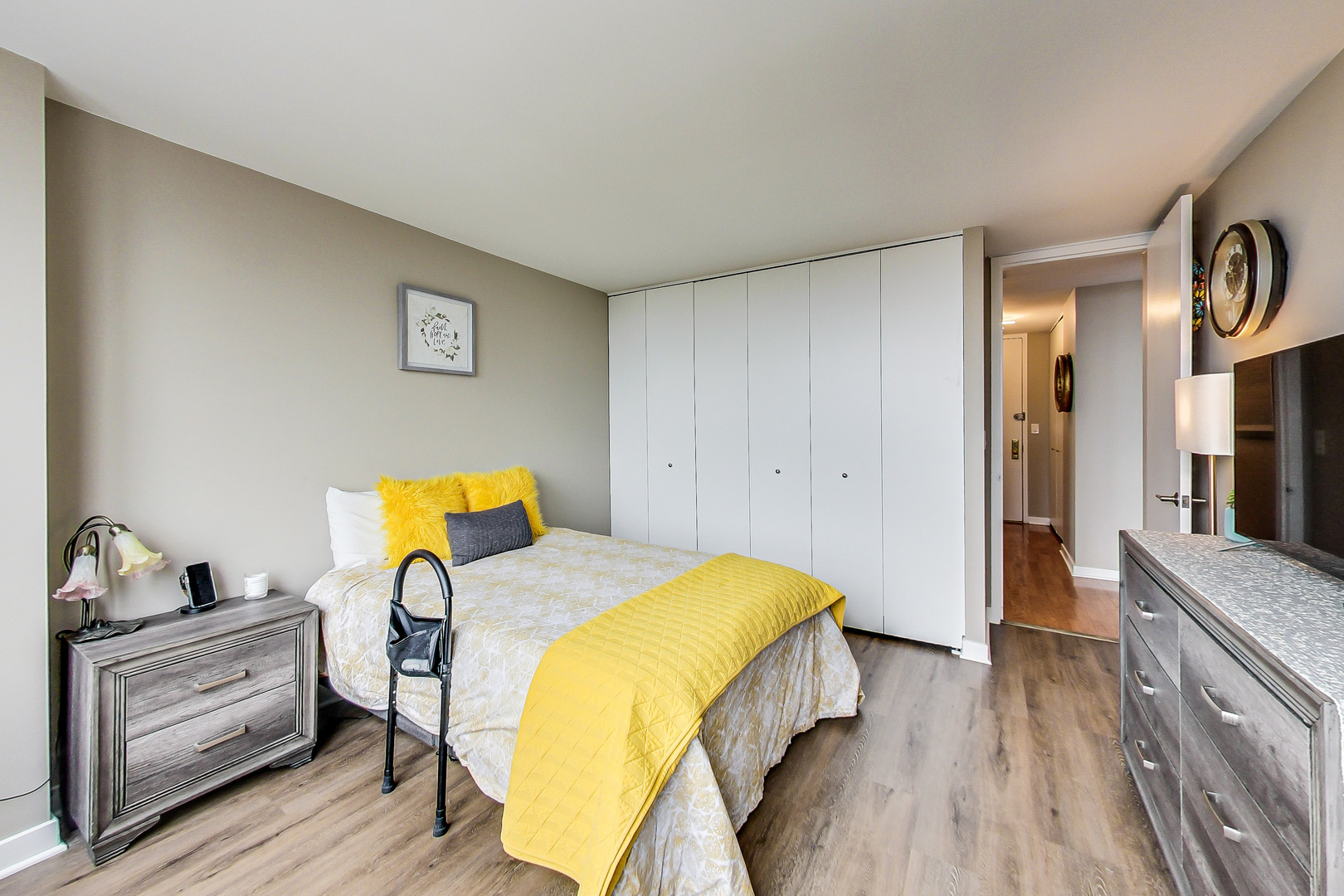 655 West Irving Park Road, Unit 2210 Chicago, IL 60613 - Photo 16 of 38 a bedroom with a bed and wooden floor