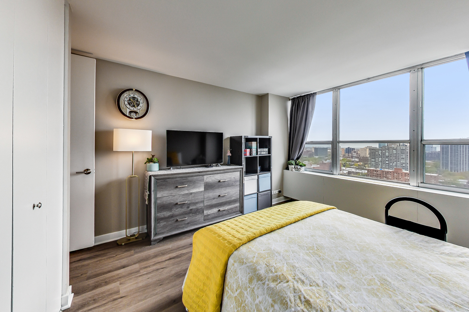 655 West Irving Park Road, Unit 2210 Chicago, IL 60613 - Photo 17 of 38 a bedroom with a bed and a flat screen tv