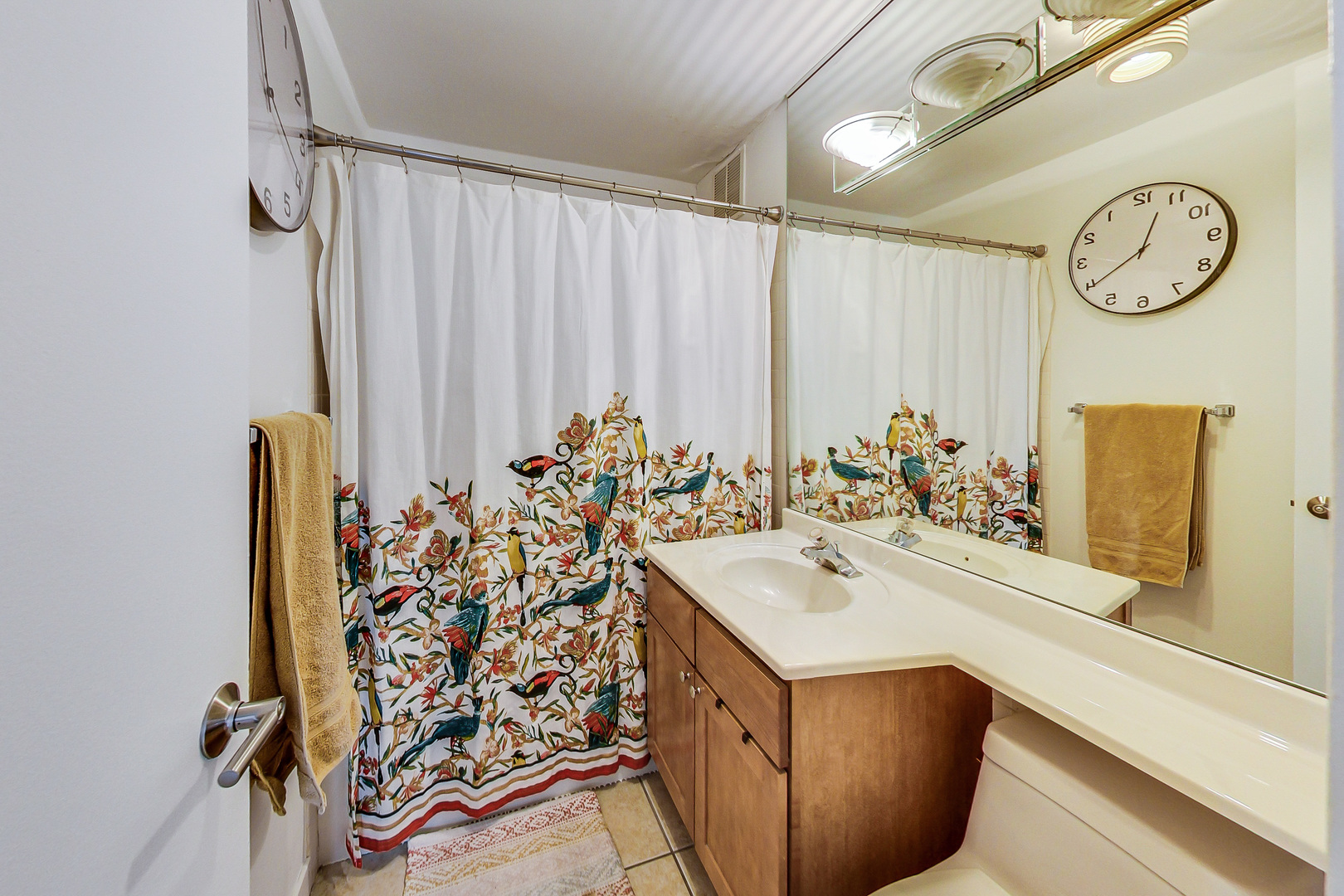 655 West Irving Park Road, Unit 2210 Chicago, IL 60613 - Photo 19 of 38 a bathroom with a sink and a mirror