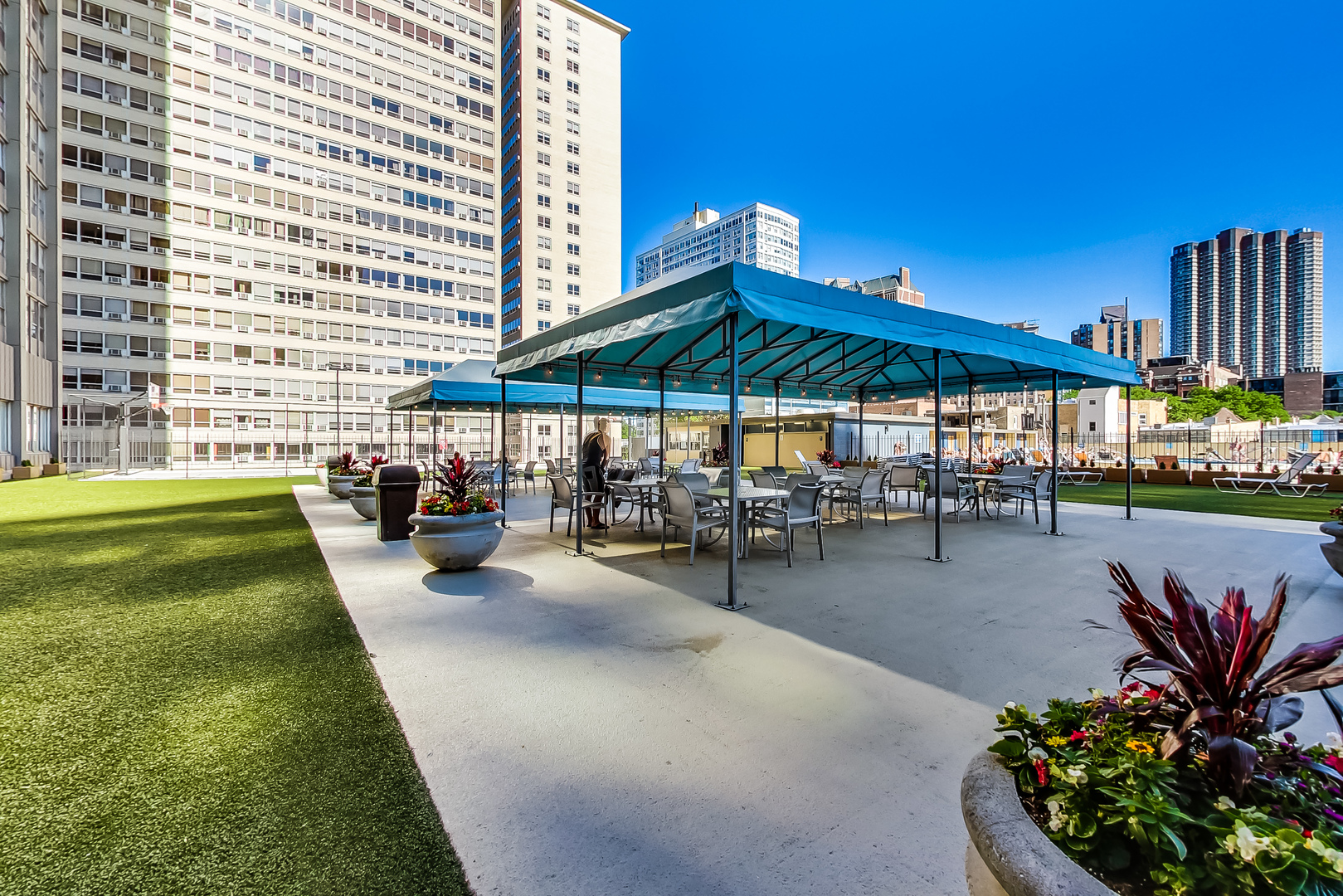 655 West Irving Park Road, Unit 2210 Chicago, IL 60613 - Photo 28 of 38 a view of a swimming pool with chairs in patio