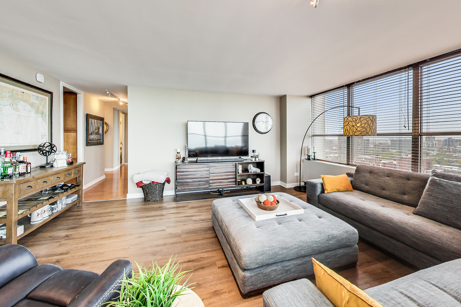655 West Irving Park Road, Unit 2210 Chicago, IL 60613 - Photo 4 of 38 a living room with furniture and a flat screen tv