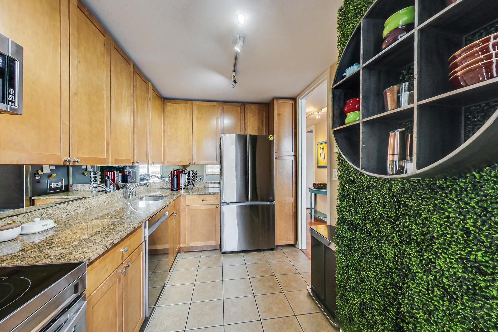 655 West Irving Park Road, Unit 2210 Chicago, IL 60613 - Photo 9 of 38 a kitchen with stainless steel appliances granite countertop a refrigerator and a sink