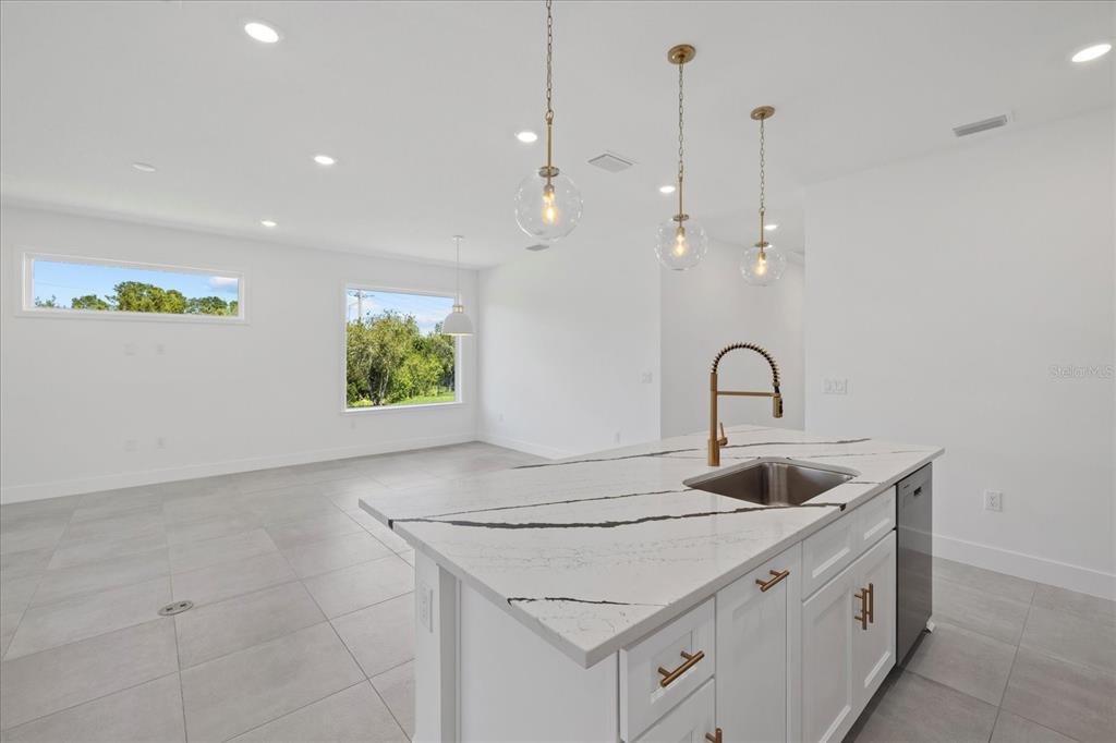 7443 South Seagrape Road Punta Gorda, FL 33955 - Photo 13 of 44 a kitchen that has a sink a stove and window