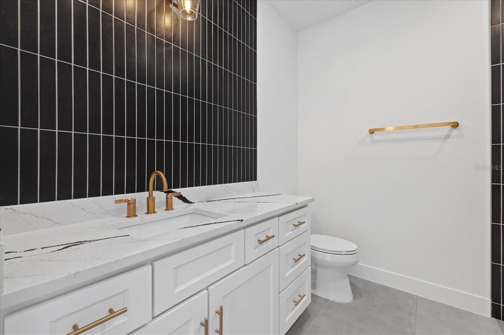 7443 South Seagrape Road Punta Gorda, FL 33955 - Photo 18 of 44 a bathroom with a granite countertop toilet and sink