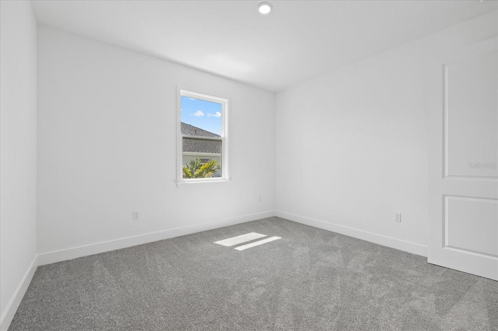 7443 South Seagrape Road Punta Gorda, FL 33955 - Photo 21 of 44 an empty room with a window