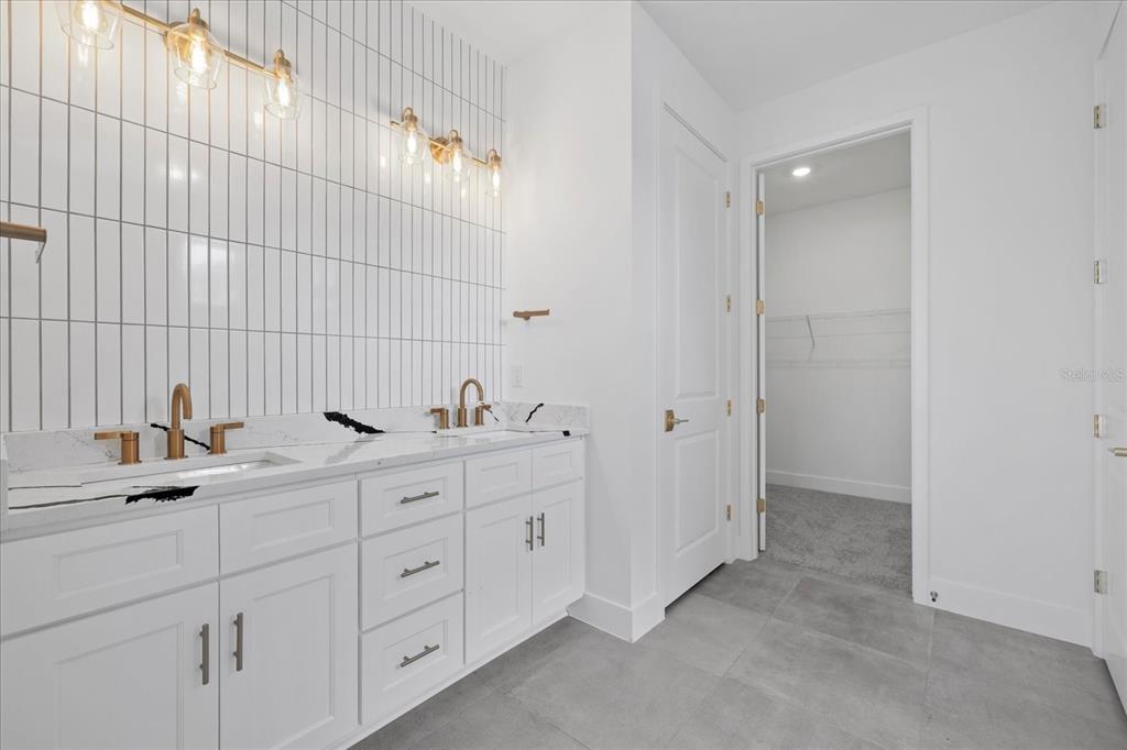 7443 South Seagrape Road Punta Gorda, FL 33955 - Photo 28 of 44 a bathroom with a double vanity sink and mirror