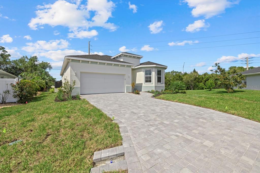 7443 South Seagrape Road Punta Gorda, FL 33955 - Photo 38 of 44 a front view of a house with a yard and garage
