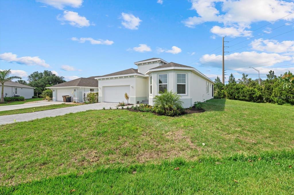7443 South Seagrape Road Punta Gorda, FL 33955 - Photo 39 of 44 a front view of a house with garden