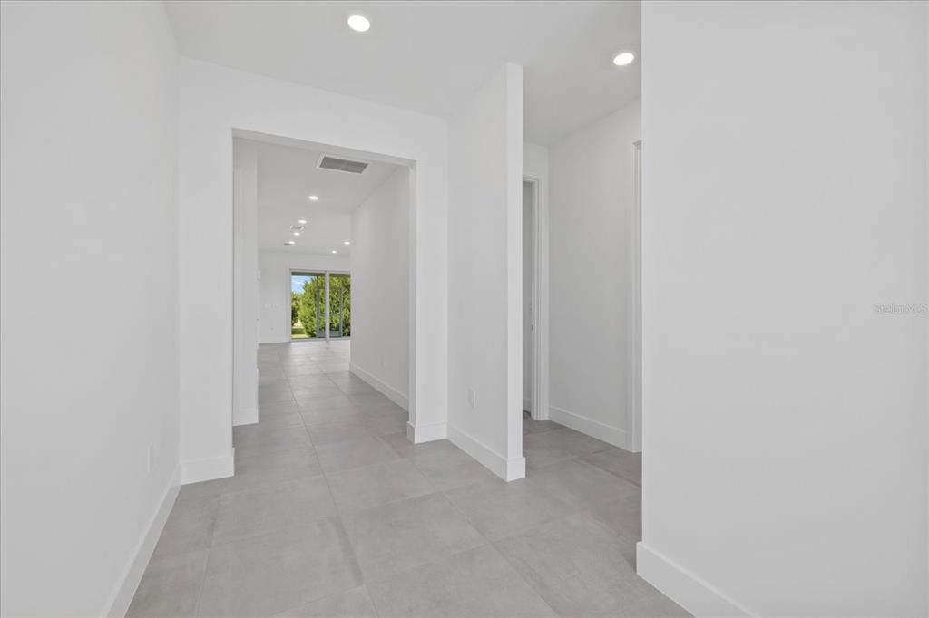 7443 South Seagrape Road Punta Gorda, FL 33955 - Photo 4 of 44 a view of a hallway with wooden floor