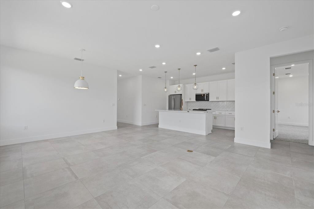 7443 South Seagrape Road Punta Gorda, FL 33955 - Photo 6 of 44 a view of a kitchen with white cabinets and stainless steel appliances