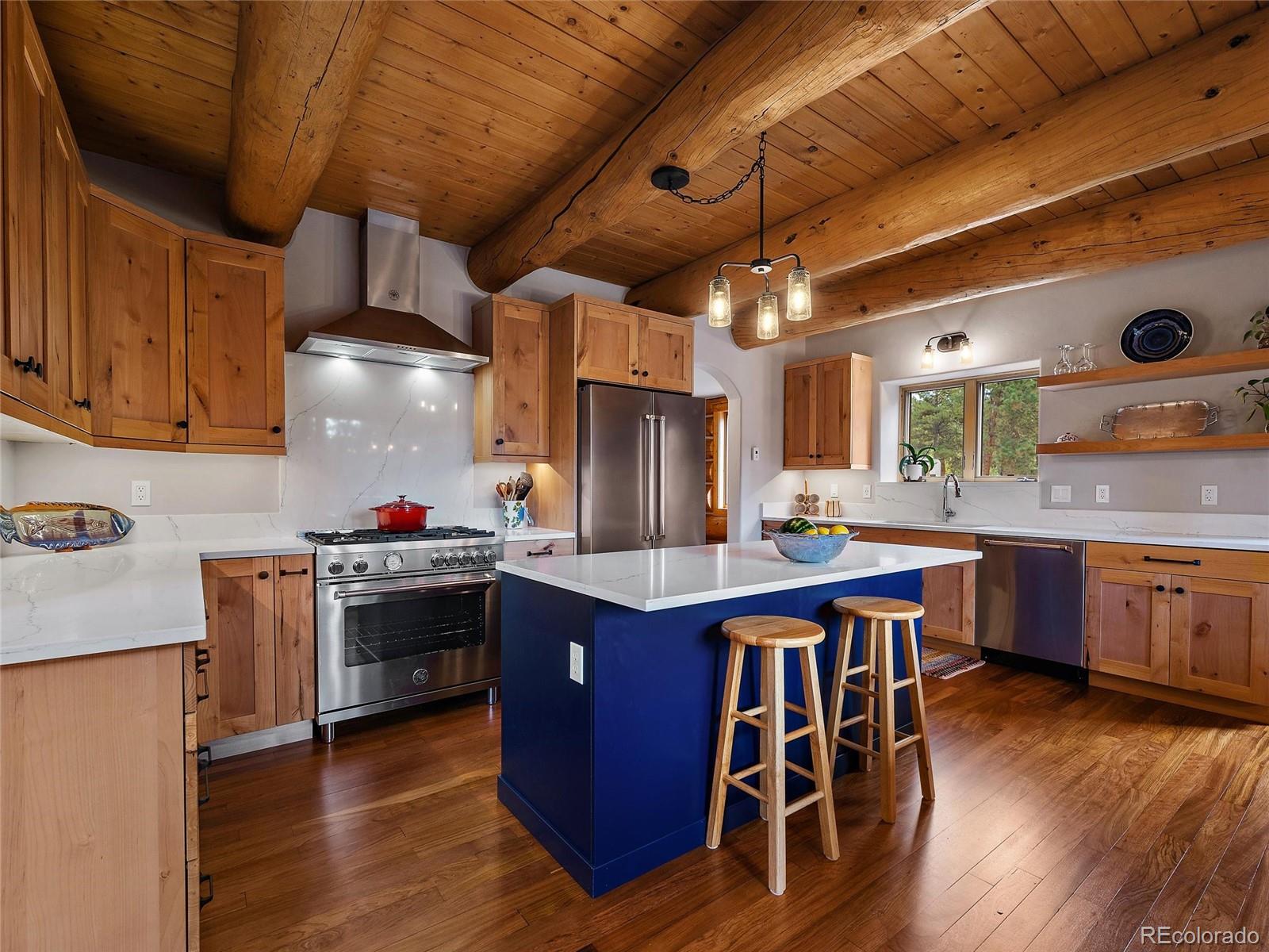 96 Six Bits Street Bailey, CO 80421 - Photo 13 of 40 a kitchen with stainless steel appliances granite countertop a stove a sink dishwasher and a refrigerator with wooden floor