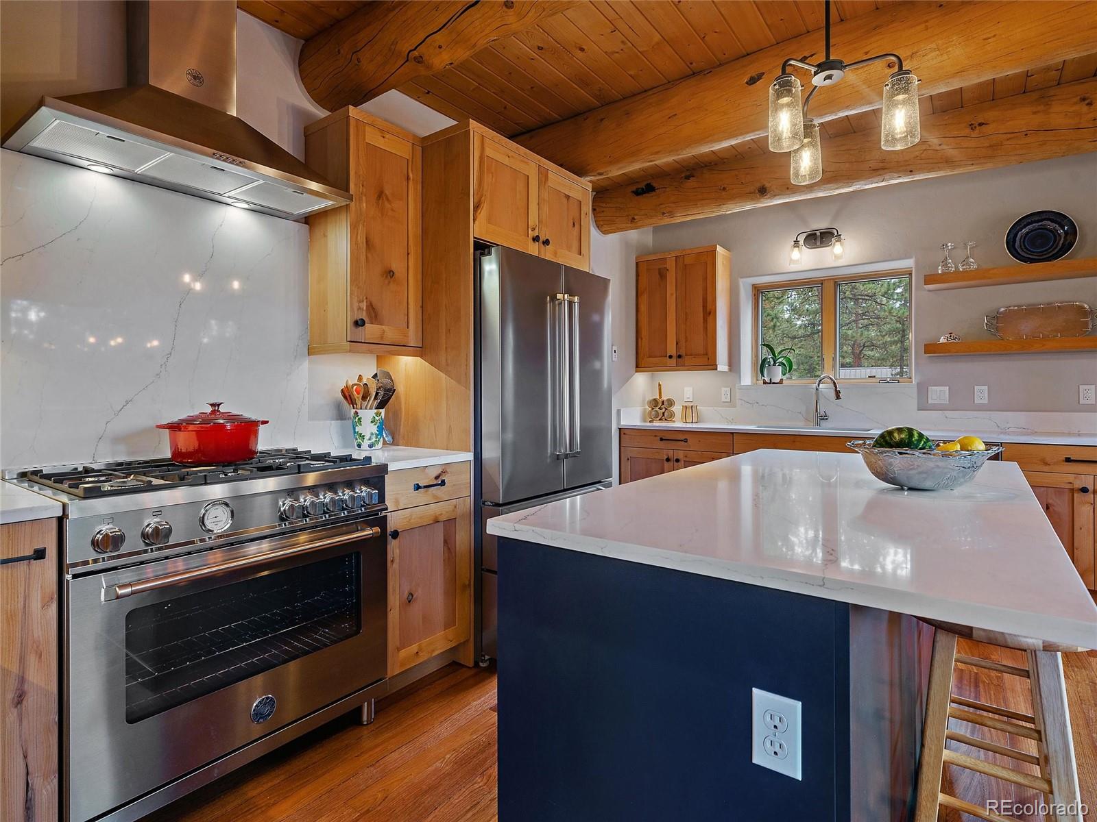 96 Six Bits Street Bailey, CO 80421 - Photo 15 of 40 a kitchen with stainless steel appliances granite countertop a sink a stove and a refrigerator