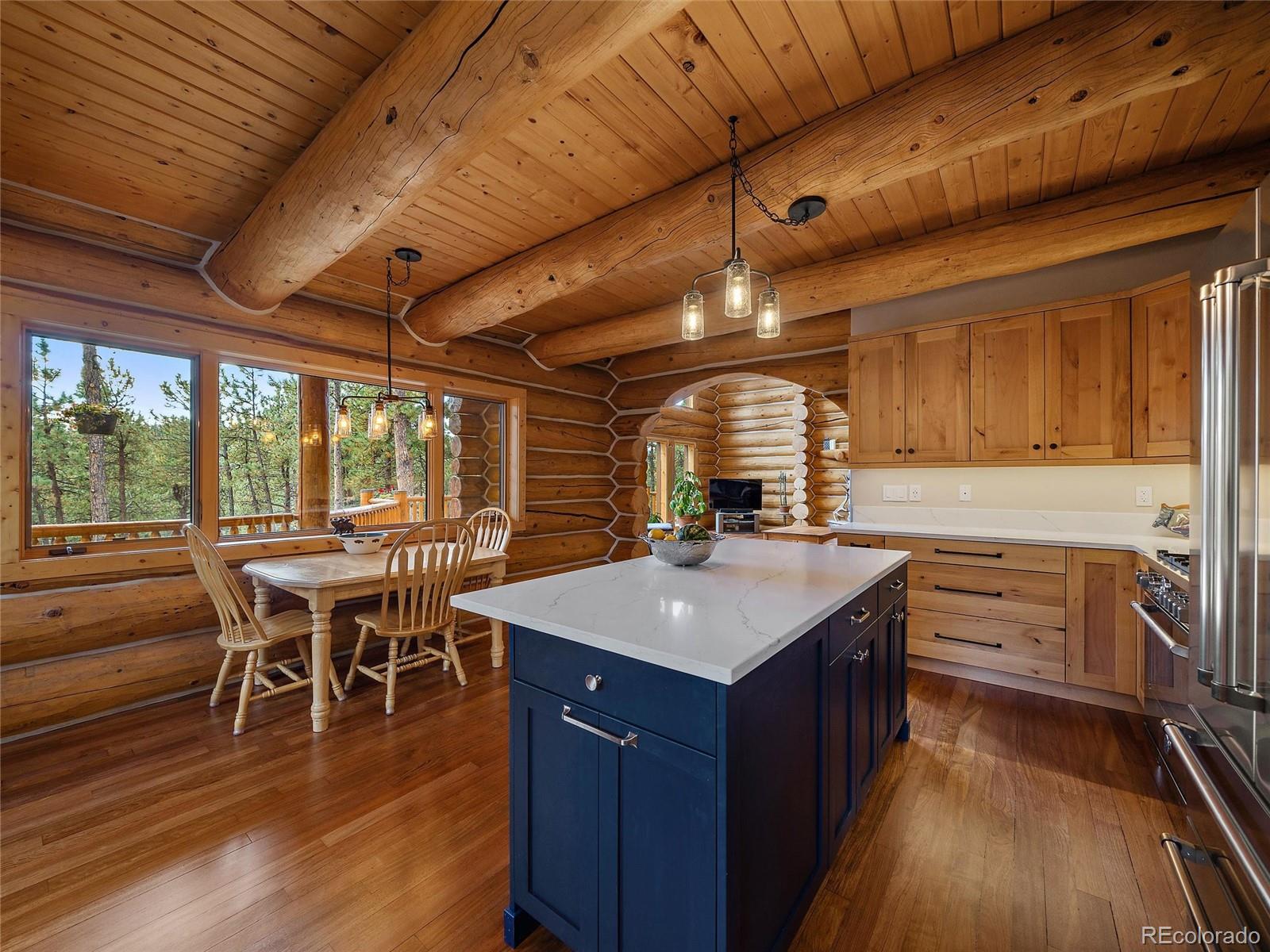 96 Six Bits Street Bailey, CO 80421 - Photo 17 of 40 a kitchen with a stove a counter top space a sink and cabinets