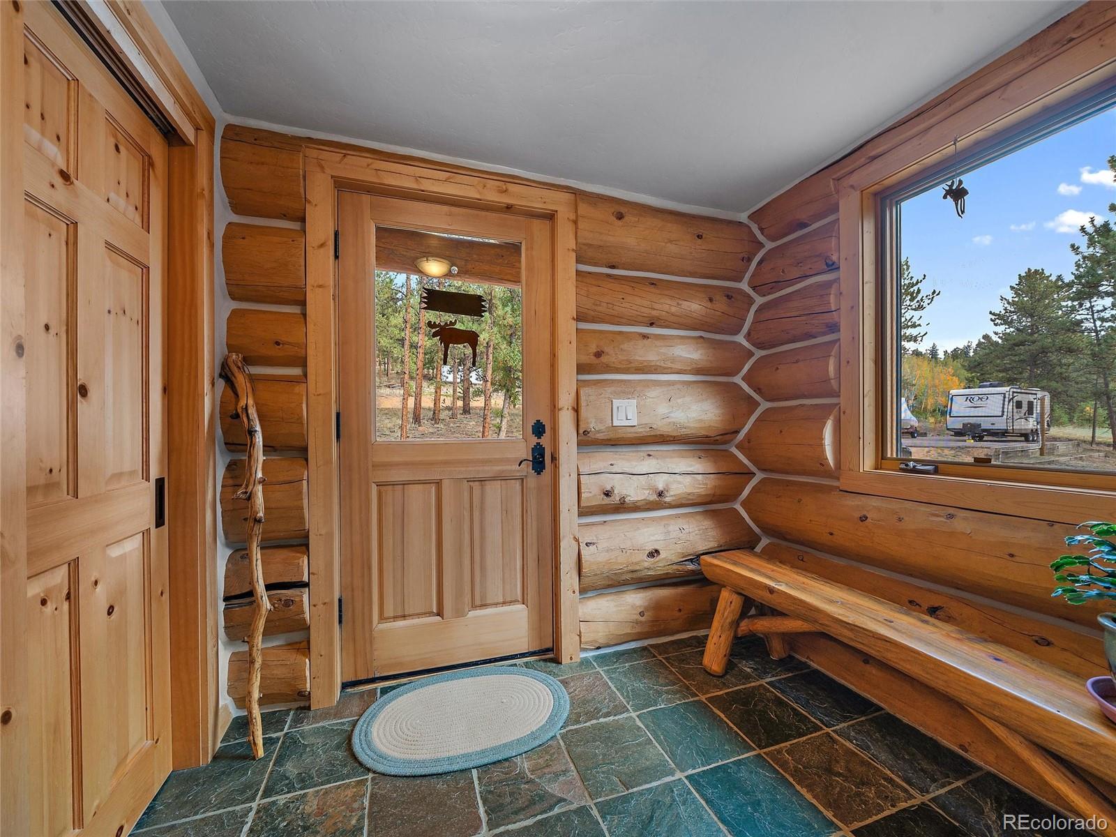 96 Six Bits Street Bailey, CO 80421 - Photo 18 of 40 a room with walk in closet and wooden floor