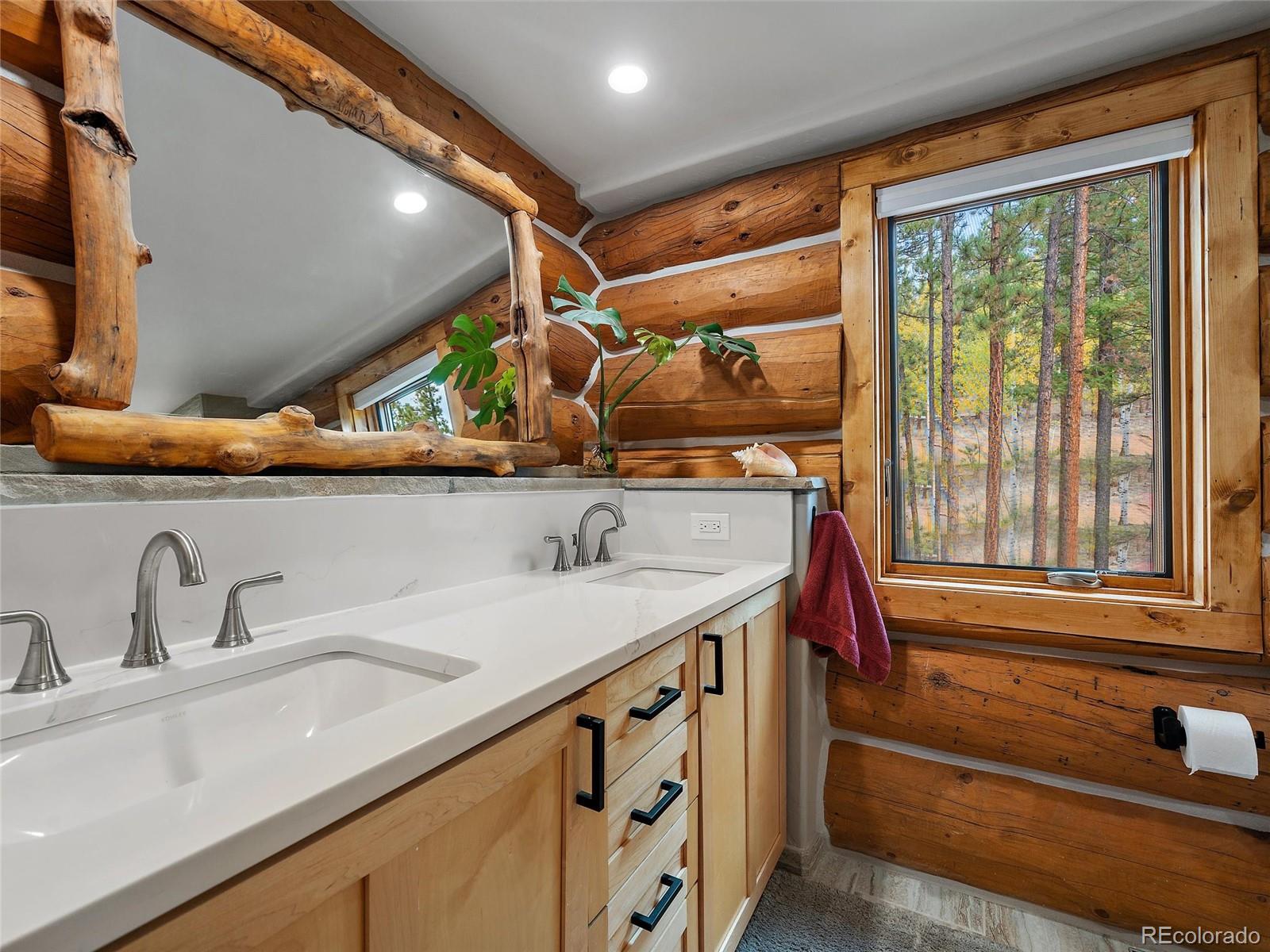 96 Six Bits Street Bailey, CO 80421 - Photo 22 of 40 a bathroom with a sink and a mirror