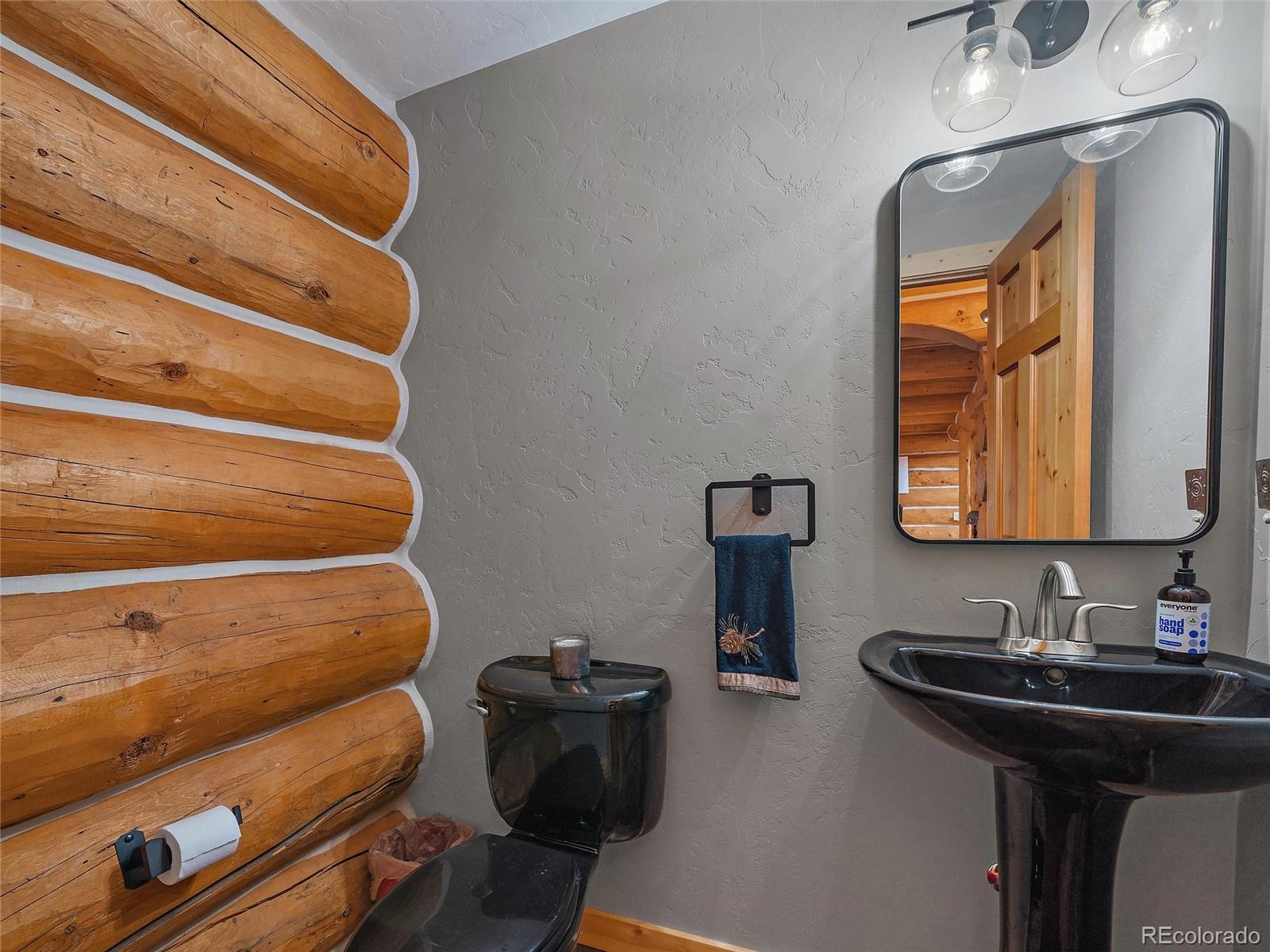 96 Six Bits Street Bailey, CO 80421 - Photo 24 of 40 a bathroom with a sink and a mirror