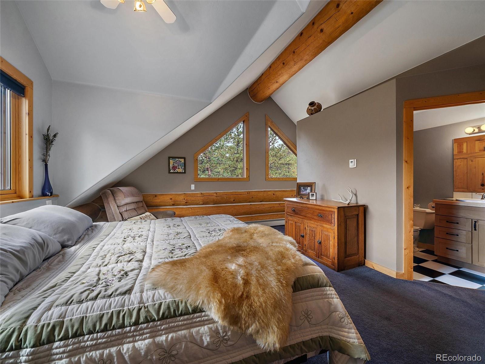 96 Six Bits Street Bailey, CO 80421 - Photo 29 of 40 a bed sitting in a bedroom next to a window