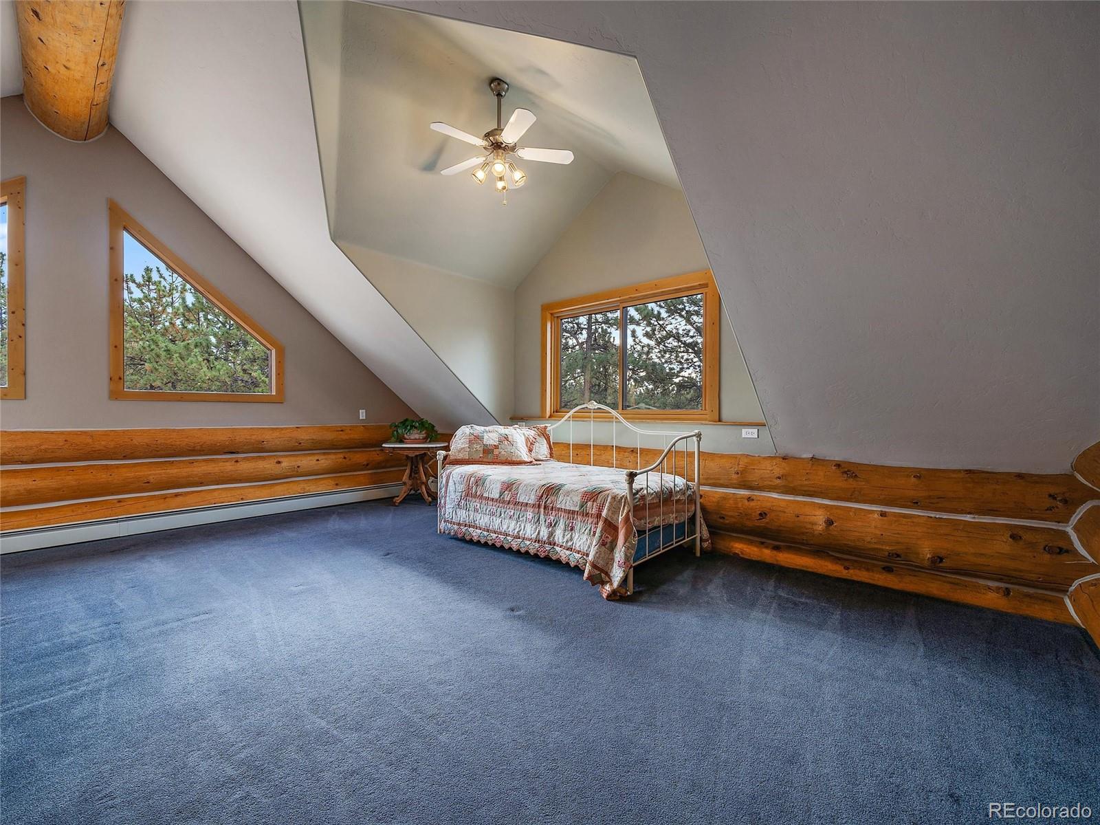 96 Six Bits Street Bailey, CO 80421 - Photo 31 of 40 a bedroom with a bed and a chandelier