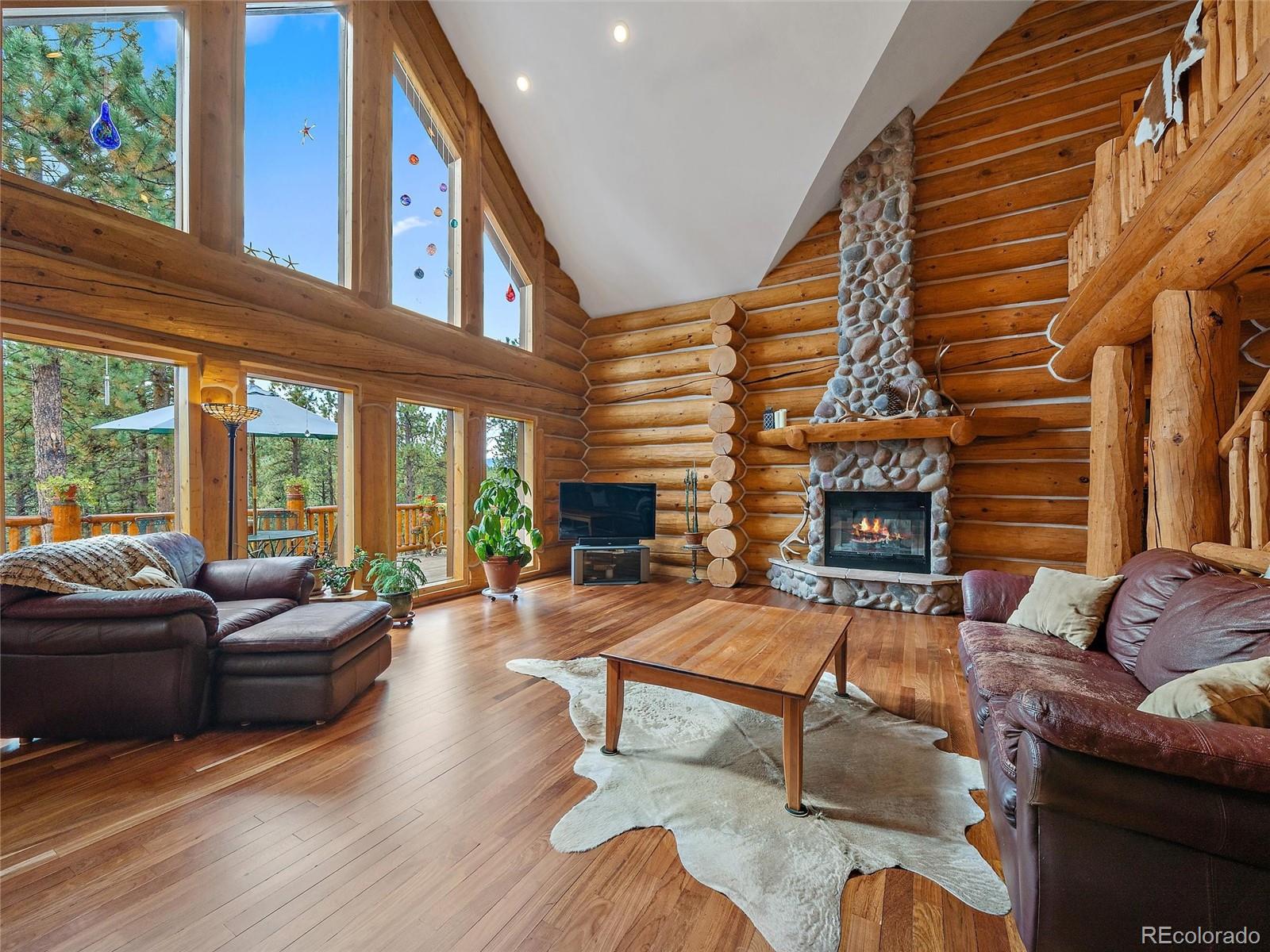 96 Six Bits Street Bailey, CO 80421 - Photo 5 of 40 a living room with furniture and a fireplace