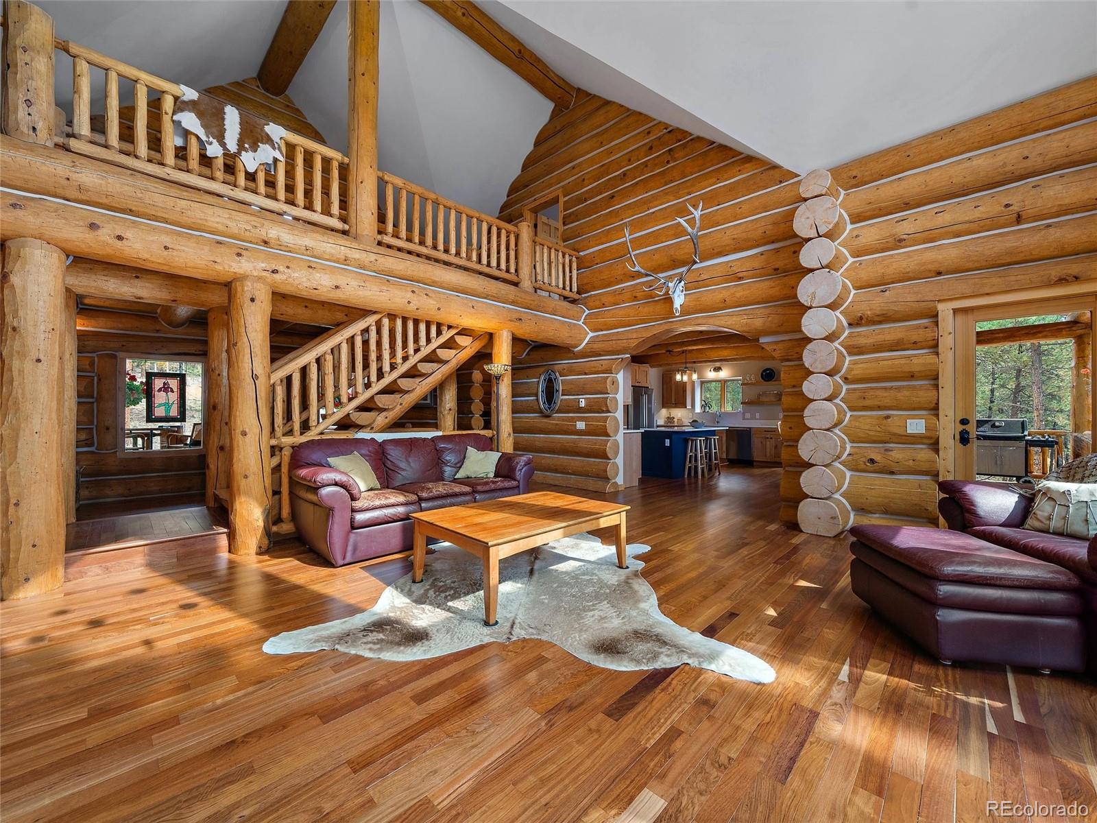 96 Six Bits Street Bailey, CO 80421 - Photo 7 of 40 a living room filled with furniture hardwood floor and a kitchen view
