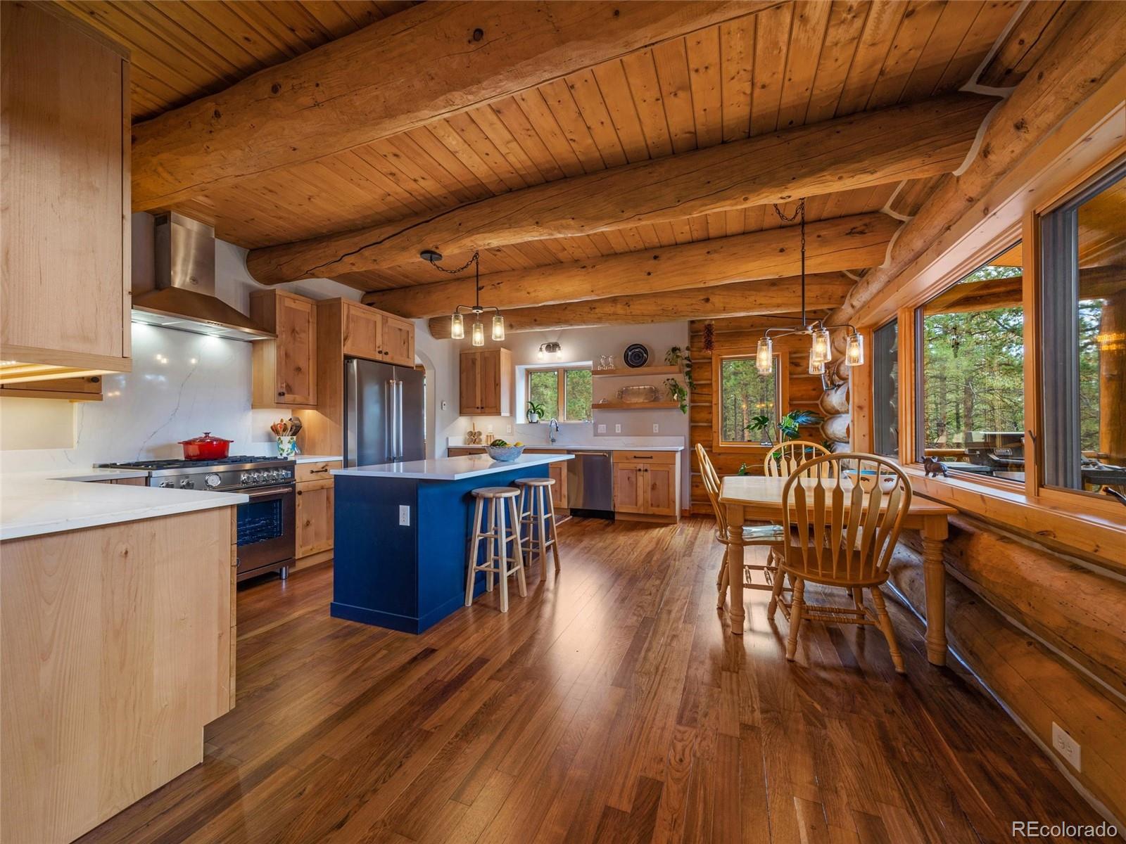 96 Six Bits Street Bailey, CO 80421 - Photo 8 of 40 a kitchen with wooden floors and wooden cabinets