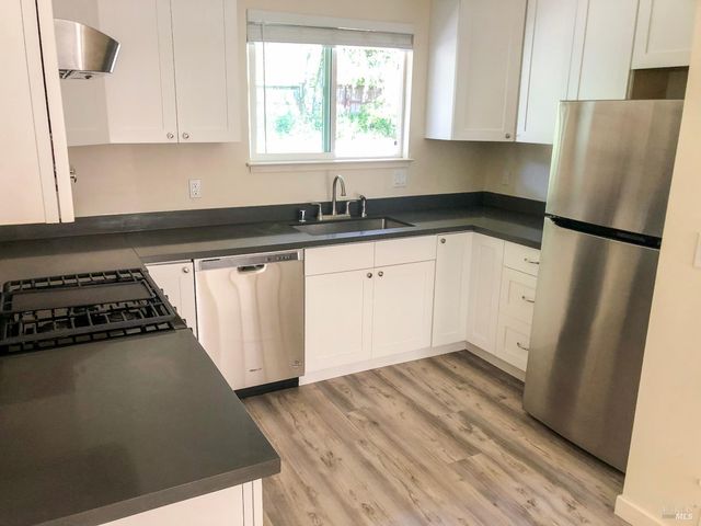 a kitchen with a refrigerator stove and sink