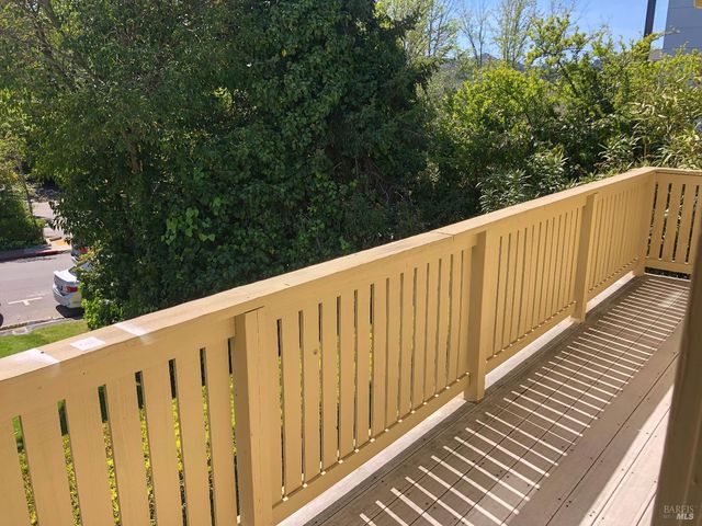 a view of wooden balcony with wooden floor and fence