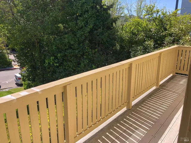 a view of wooden balcony with wooden floor and fence
