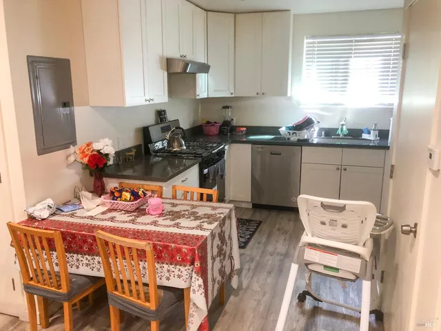 a kitchen with a table chairs stove and cabinets