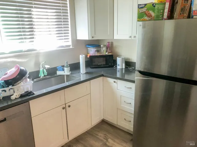 a kitchen with a refrigerator and window