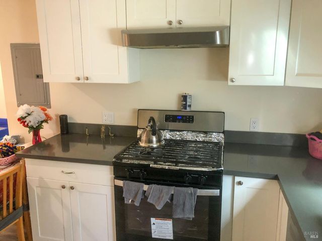 a kitchen with a stove and cabinets