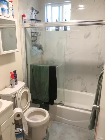a bathroom with a sink toilet and shower
