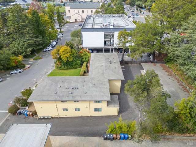 an aerial view of a house with a yard and a fountain