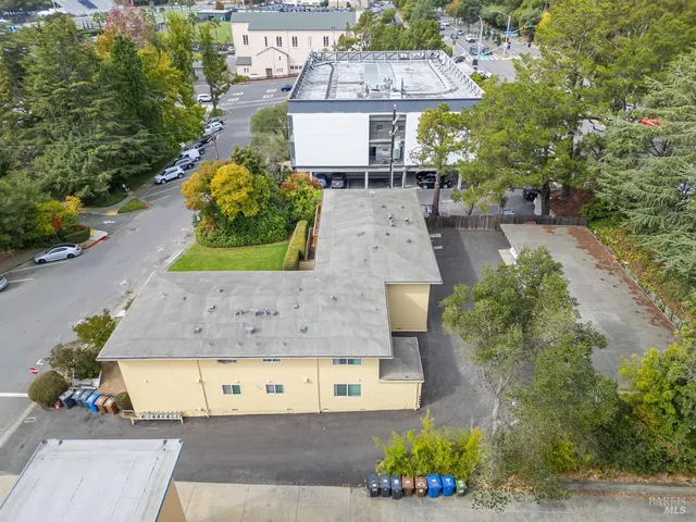 an aerial view of a house with a yard and a fountain