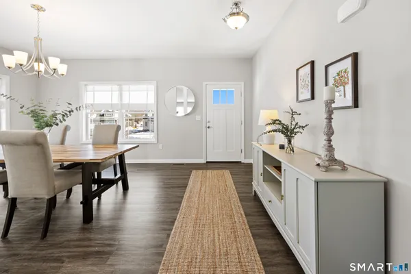 a view of a dining room with furniture and wooden floor
