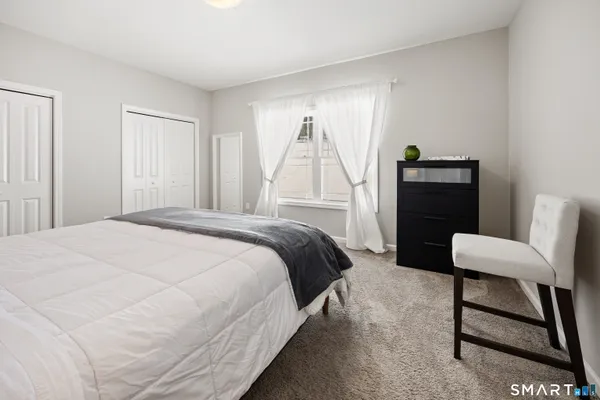 a bedroom with a bed and a chair
