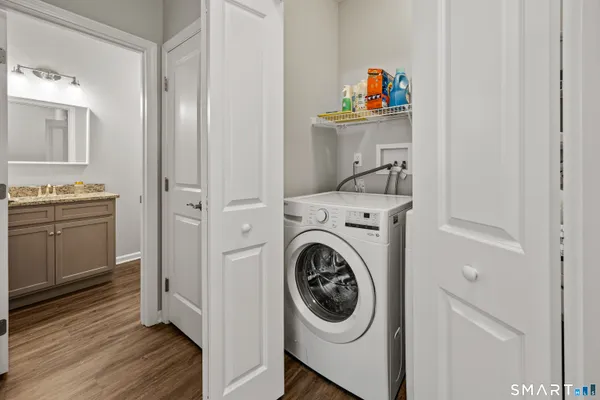 a utility room with sink dryer and washer