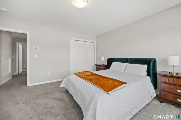 a bedroom with a bed and a lamp