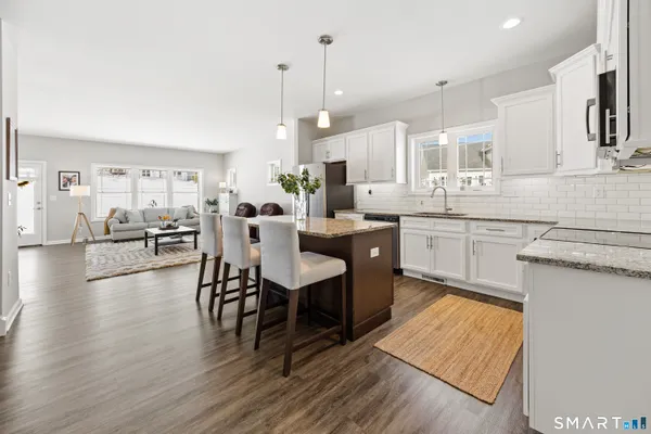 a large kitchen with cabinets table and chairs
